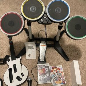 Nintendo Wii and rock band set with 3 games.
